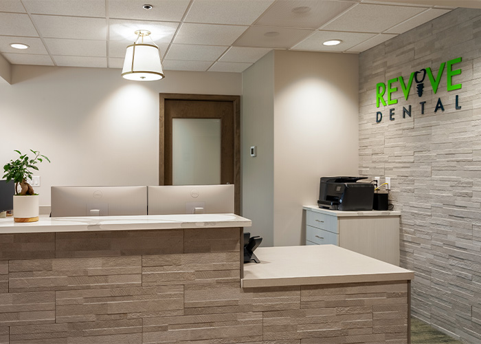Revive-Dental front desk with two monitor and a black printer on the right side.