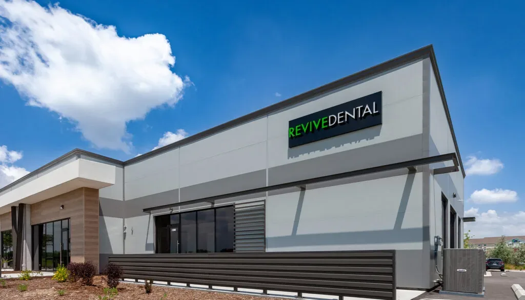 The image shows the Revive-Dental building exterior design