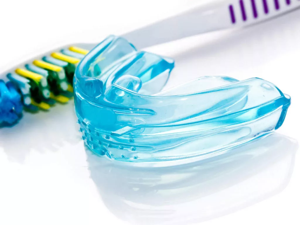 mouth guard placed next to tooth brush